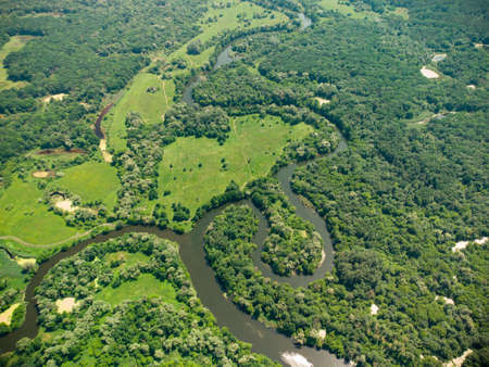 Aerial view over the river which is on the green forest. drone photoの写真素材