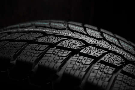 New winter tire close-up on black backroundの写真素材