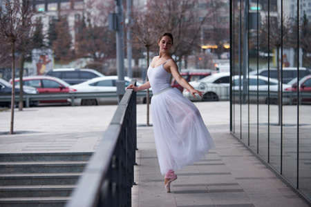 Beautiful ballerina posing in the city.