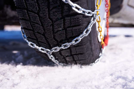 snow chain on a wheel in deep snow in winter road