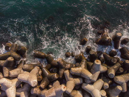 Aerial drone top view of a breakwater. breakwater in the sea, a collection of concrete breakers