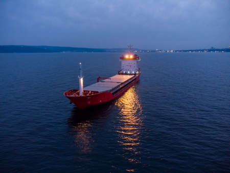 Large general cargo ship tanker bulk carrier, Top down aerial view at night.の写真素材