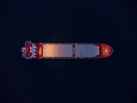 Large general cargo ship tanker bulk carrier, Top down aerial view at night.の写真素材