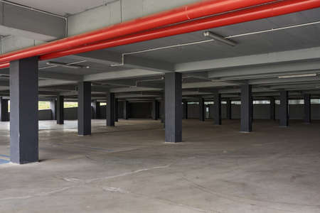 Empty underground parking lot garage interior with concrete columns.の写真素材