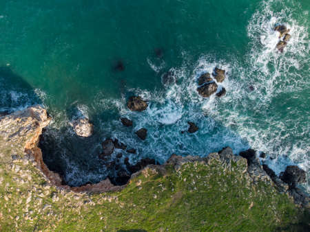 Aerial top view of sea waves and fantastic cliffs, rocky coast. Tyulenovo, Bulgariaの写真素材