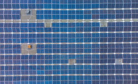 Solar panels installed on a roof of a large building. Aerial viewの写真素材
