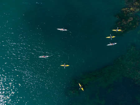 Aerial view of a small group of people sea kayakingの写真素材