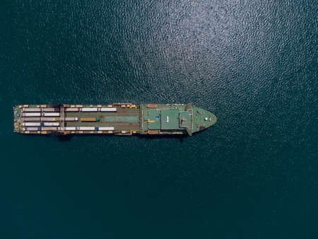 Aerial view of a ferry boat transporting trucks in the seaの写真素材