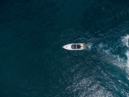 Aerial view of speed motor boat on open blue sea