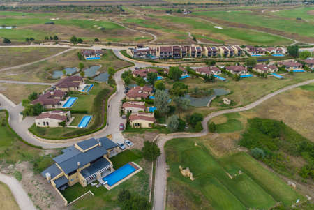 Modern cottage village with luxury houses, swimming pools and golf courses aerial view.の写真素材