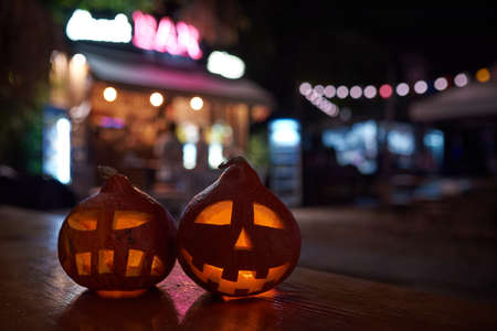two carved pumpkins during the halloween celebration at night in the city.の写真素材