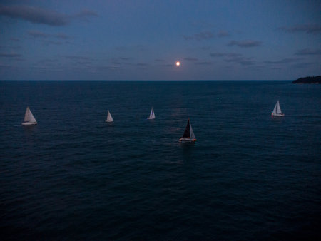 Luxury yachts at Sailing regatta at fool moon night.