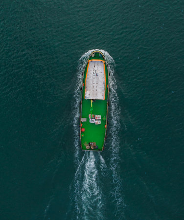 Aerial drone view of industrial tug assisting boat in deep seaの写真素材