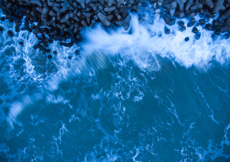 Aerial view of stormy sea with concrete pierの写真素材