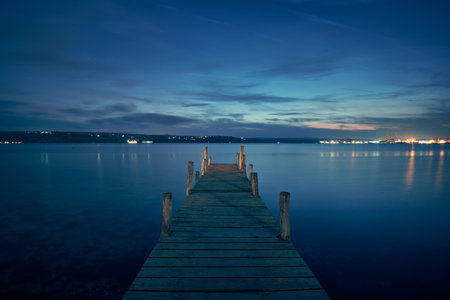 Landscape photo of a jetty on lake at night in Varna, Bulgaria.