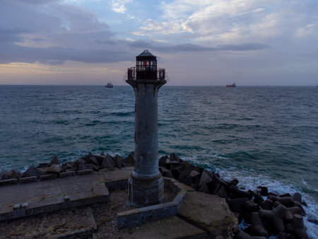 flying around the lighthouse on a drone early in the morning at sunriseの写真素材