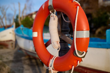 Orange lifebuoy hang on the pierの写真素材