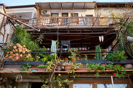 old balcony in a coastal town with plants and hanging clothesの写真素材