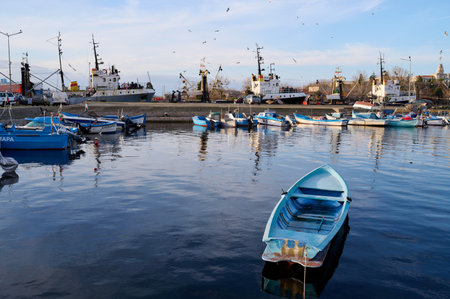 Sozopol, Bulgaria - DECEMBER 18, 2022: Fishing boats in the marina at sunsetのeditorial素材