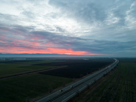 Aerial view of highway road at sunset in autumn. Top view from drone of roadの写真素材