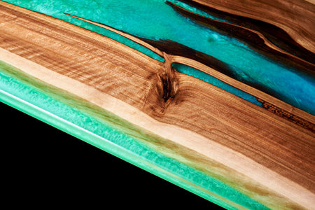 Texture of a wooden table with epoxy resin isolated on blackの写真素材