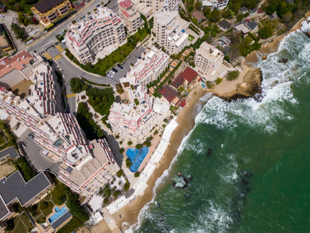 A stunning aerial view of an exclusive residential complex nestled by the sea, boasting luxurious amenities and breathtaking oceanfront panoramas.の写真素材