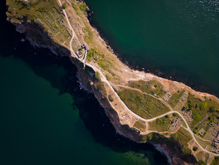 aerial top view of Cape Kaliakra, Bulgaria's enchanting headland. Marvel at the majestic cliffs, ancient fortress, and panoramic sea vistas that make this coastal gem truly captivatingの写真素材