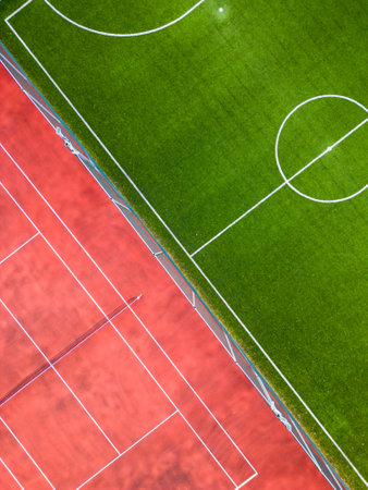Aerial view of a soccer field and a tennis court, spaces for activity and competition.の写真素材