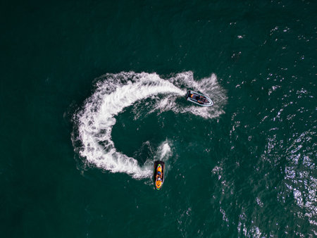 Aerial view of a personal watercraft speeding through the waves, creating a mesmerizing trail.の写真素材