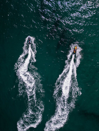 Aerial view of a personal watercraft speeding through the waves, creating a mesmerizing trail.の写真素材