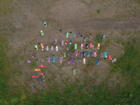 Aerial view of yoga class on the green grass outdoor.の写真素材