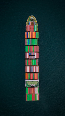A loaded container ship in the sea, aerial top view, concept of international trade and shippingの写真素材