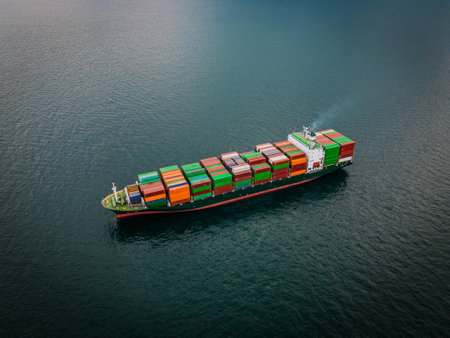 A loaded container ship in the sea, aerial top view, concept of international trade and shippingの写真素材