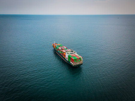 A loaded container ship in the sea, aerial top view, concept of international trade and shippingの写真素材