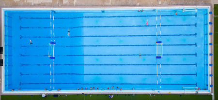 Aerial drone top view of swimming pool with athletes training water poloの写真素材