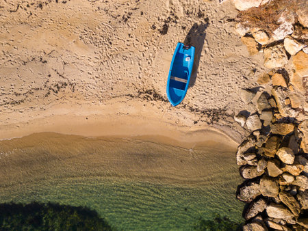 Aerial view of a fishing boat on the shore of the seaの写真素材