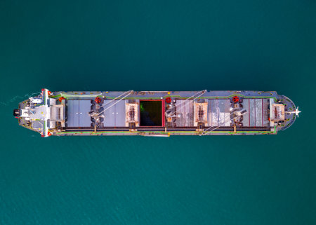 A massive cargo ship wood chips carrier in the sea, aerial view.の写真素材