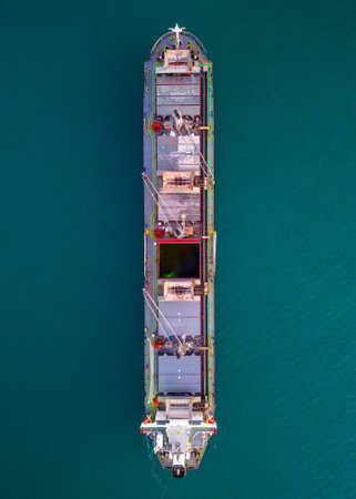 A massive cargo ship wood chips carrier in the sea, aerial view.の写真素材