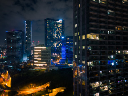 Istanbuls glass and concrete skyscrapers, home to offices, hotels, and residential complexes at night. Aerial drone viewの写真素材