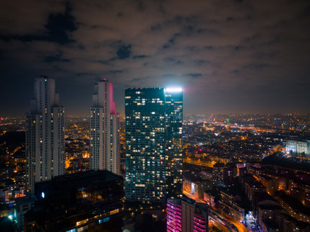 Istanbuls glass and concrete skyscrapers, home to offices, hotels, and residential complexes at night. Aerial drone viewの写真素材