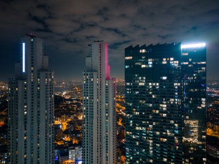 Istanbuls glass and concrete skyscrapers, home to offices, hotels, and residential complexes at night. Aerial drone viewの写真素材