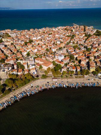 Aerial view of a coastal town Pomorie, Bulgaria, showcasing vibrant architecture along the shoreline against a backdrop of blue waters and skyの写真素材