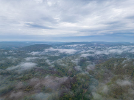 Aerial drone view flying over misty forested mountains in Strandzha National Park, Bulgaria. Foggy landscapes and green forests create a peaceful, mystical atmosphere in natureの写真素材