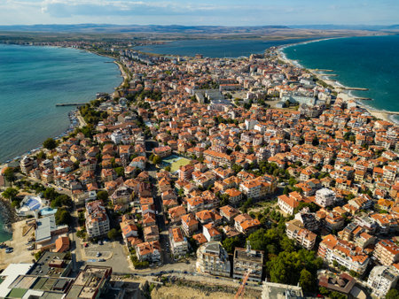 Aerial view of a coastal town Pomorie, Bulgaria, showcasing vibrant architecture along the shoreline against a backdrop of blue waters and skyの写真素材