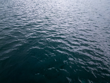 Aerial drone view of rippling dark blue sea water. The textured surface creates a serene, minimalistic scene perfect for backgrounds, oceanic themes, and nature conceptsの写真素材