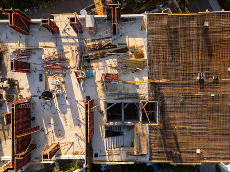 A drone video showcasing a top-down view of a construction site. The image captures the buildings...