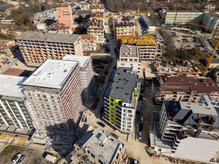 Aerial view of a cityscape with ongoing construction projects and completed residential buildings. Highlights urban development, expansion, and the growth of modern infrastructureの写真素材