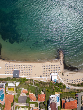 Aerial view of Sveti Vlas, a Bulgarian seaside resort town with a marina, beaches, red-roofed buildings, and green hills. Popular summer destination on the Black Sea coastの写真素材