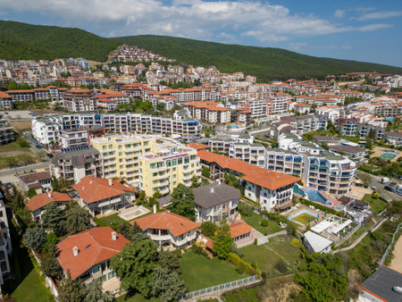 Aerial view of residential and resort buildings with red roofs in Sveti Vlas, Bulgaria. Sunny day, pools, gardens, and mountains in the background. Popular Black Sea vacation destinationの写真素材