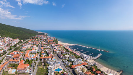 Panoramic aerial view of Sveti Vlas, Bulgaria, showing the marina, beaches, red-roofed buildings, and lush green hills along the Black Sea coast. Popular summer resort townの写真素材